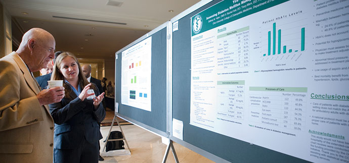 Student presenting research poster