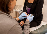 A woman receiving a health screening.
