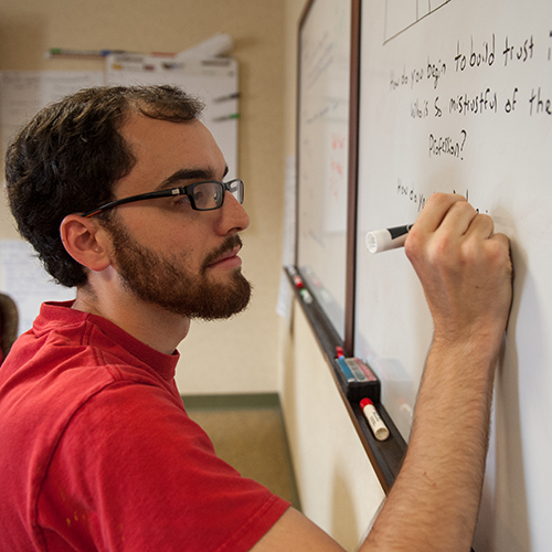 Student writes on a white board