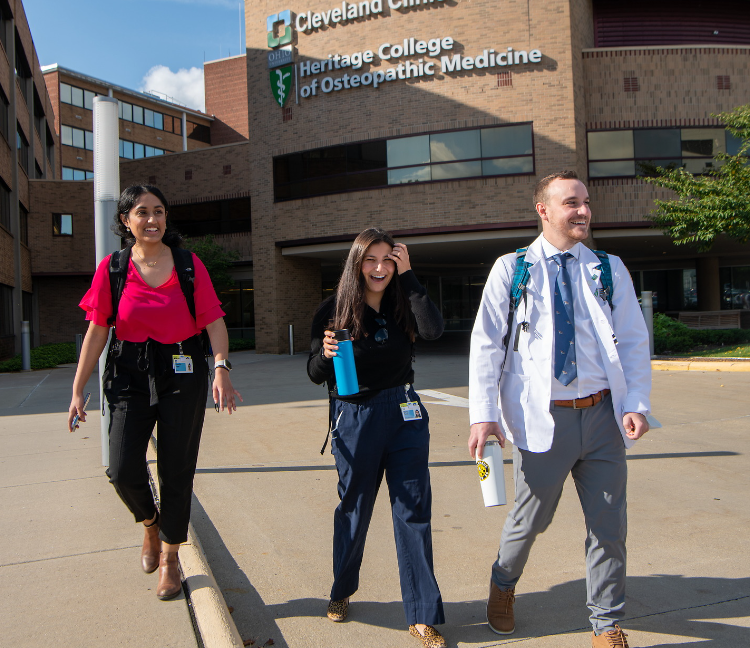 Three Heritage College students walk outside the Cleveland campus