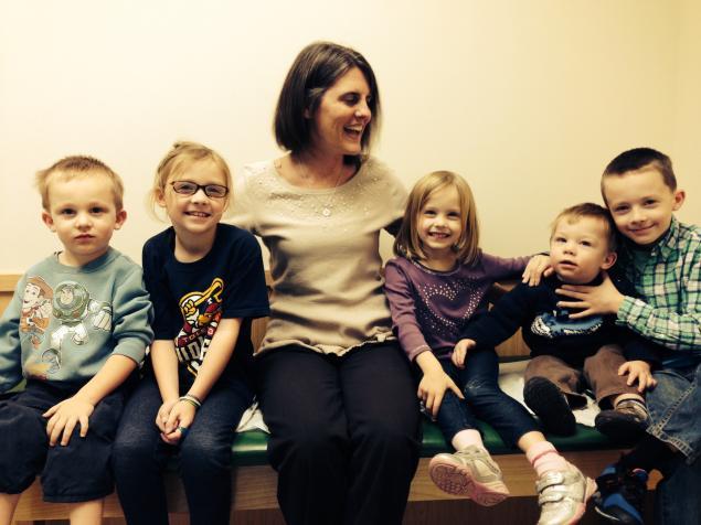 HCOM grad Karolyi with young family she cared for