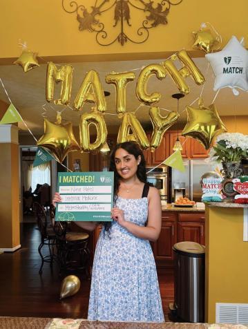 Nina Patel holding a Match Day sign