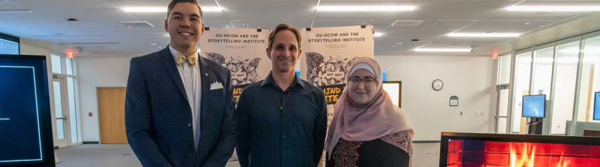 Two students and a faculty member standing side by side