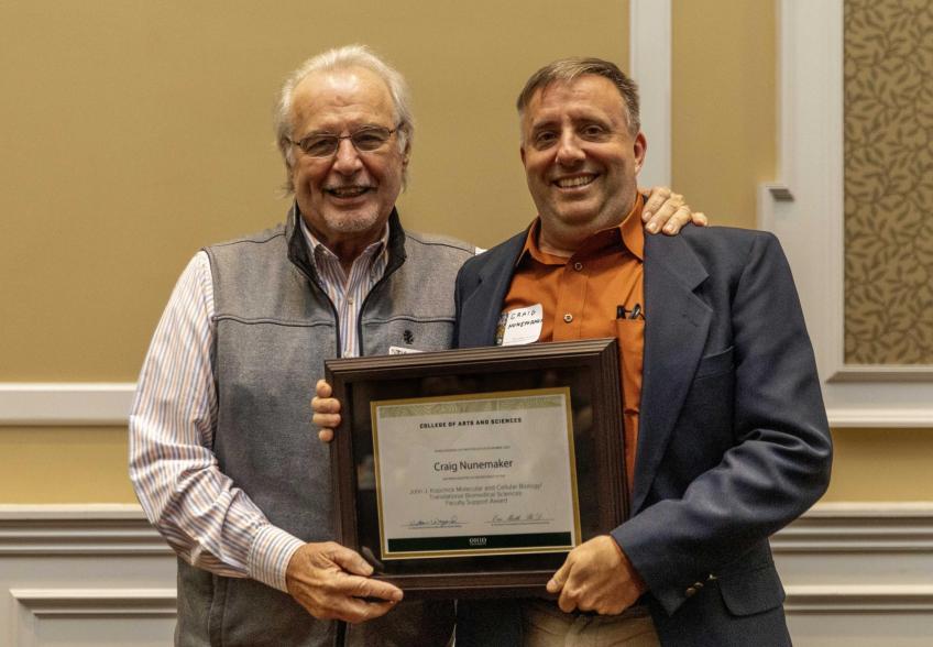 Kopchick and Nunemaker holding award certificate