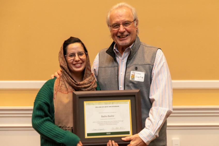 Kopchick and graduate student holding certificate