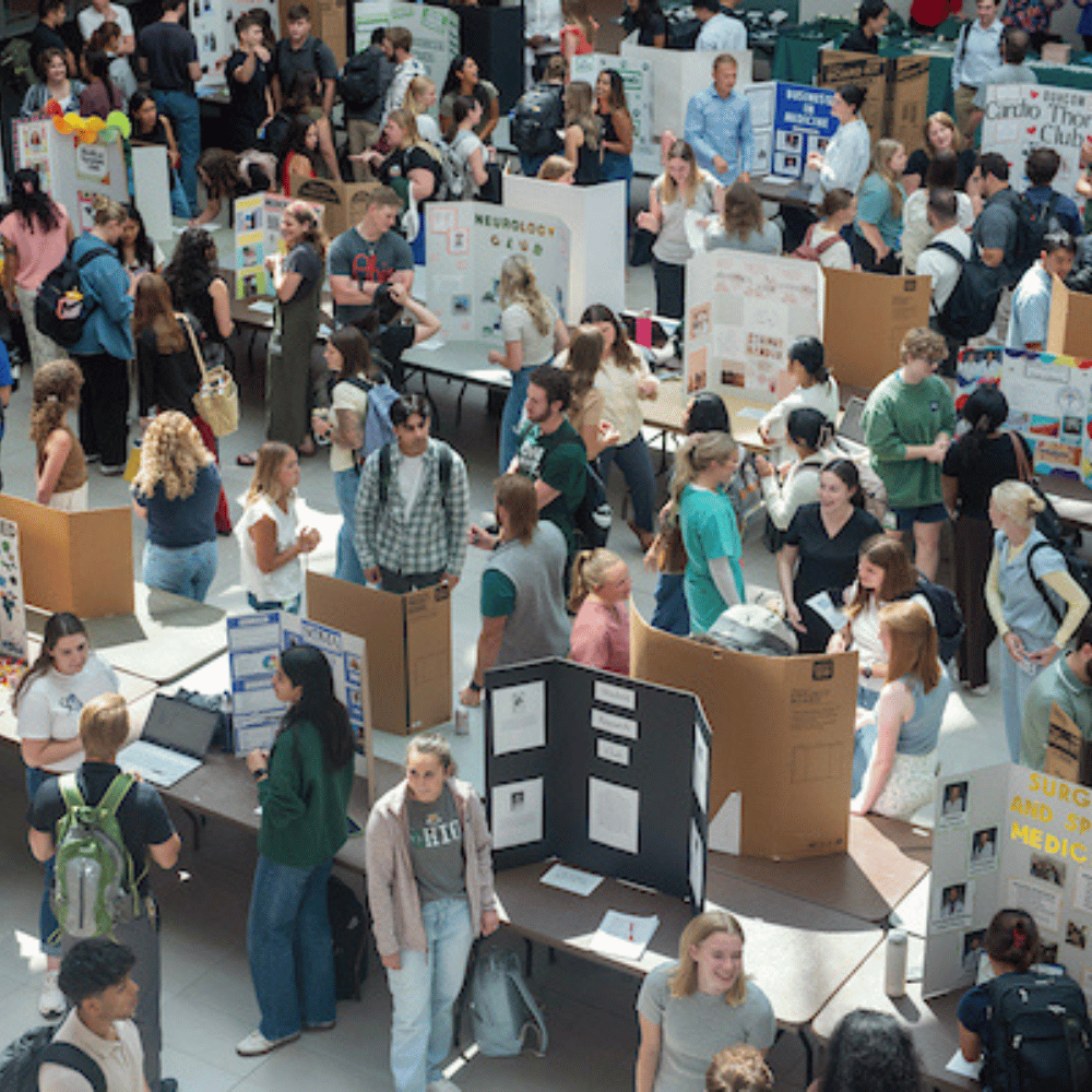 Students mingling in atrium at an organization fair