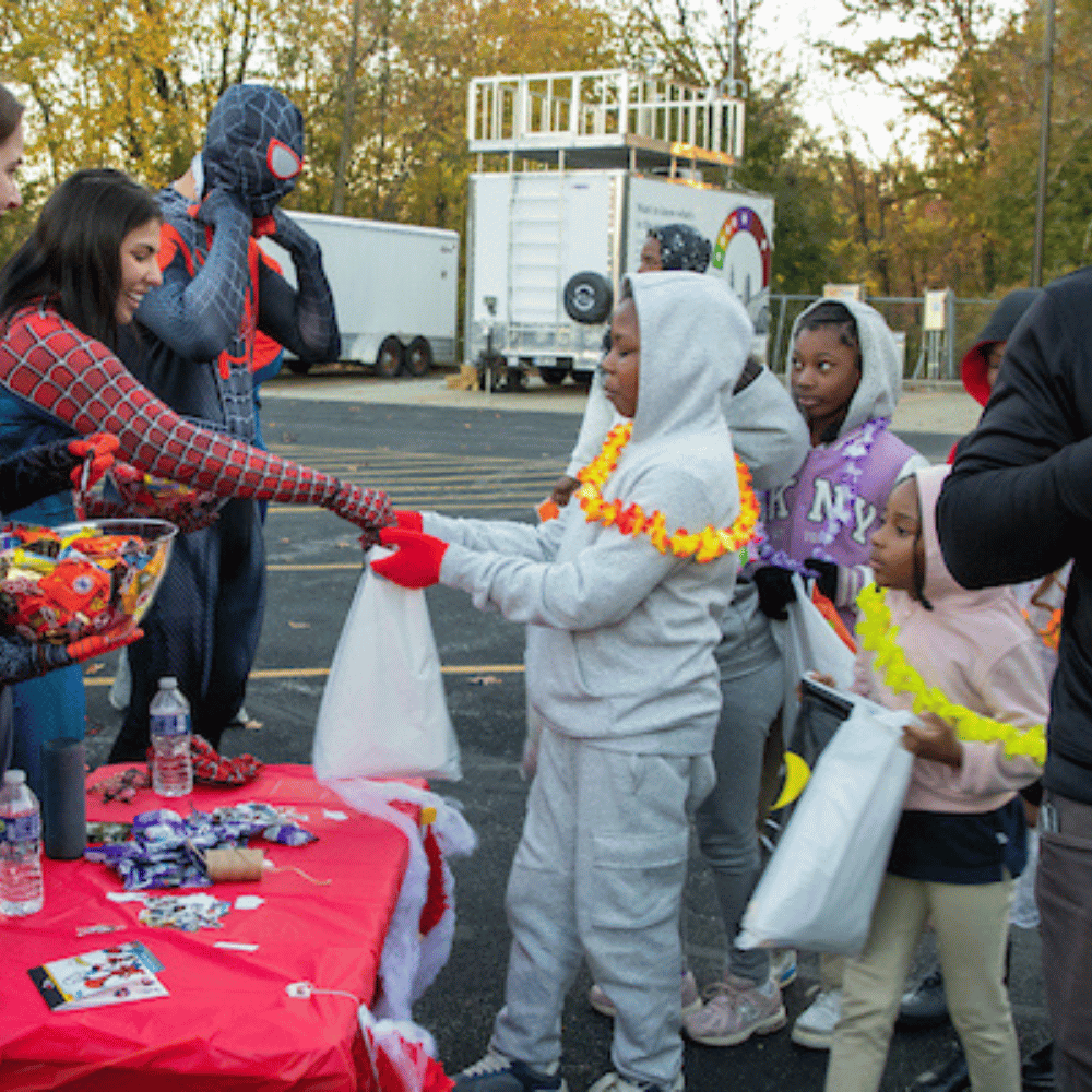 Kids lined up to get candy 