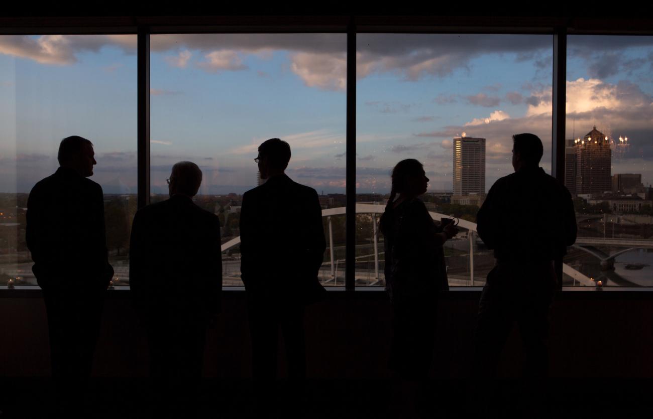 group of people in front of a window