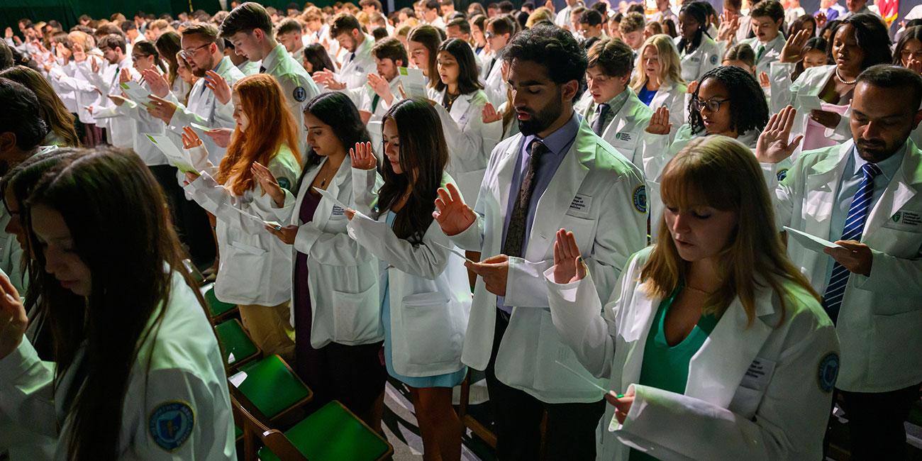 New medical students take the Osteopathic Oath during their convocation ceremony