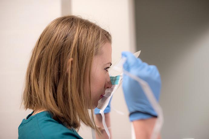 Person putting on surgical mask