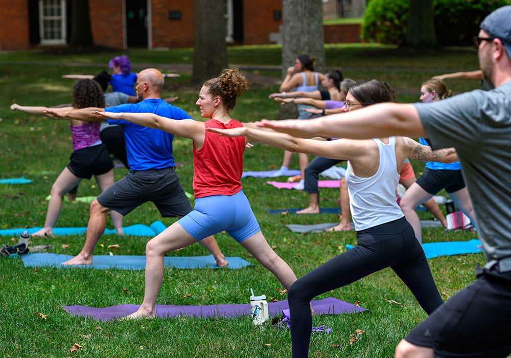 A group of people doing yoga outside