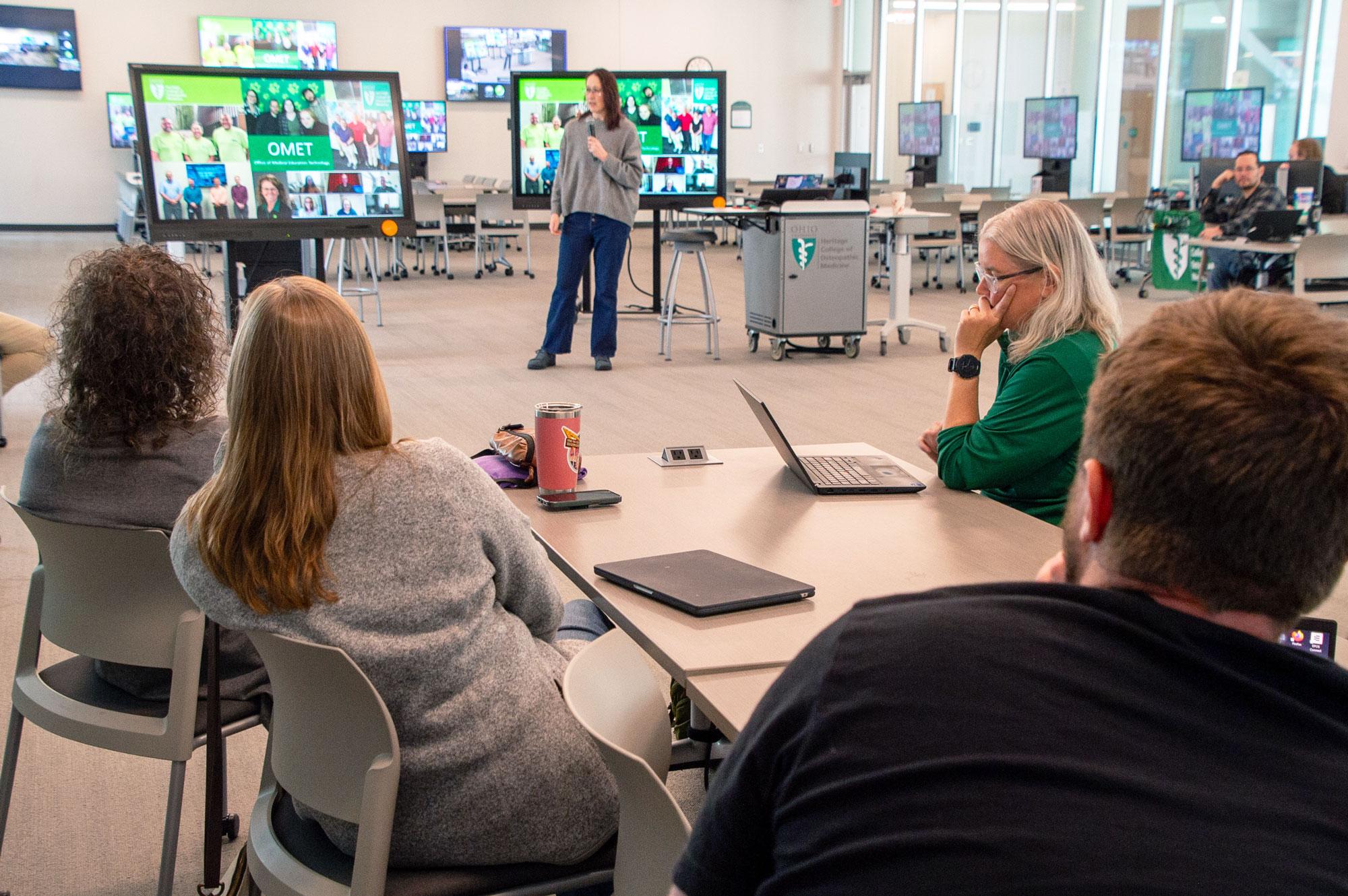 CARE Leaders cohort members listen to a presentation about technology