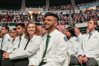 Student sit in rows during Heritage College of Osteopathic Medicine commencement on September 23, 2018