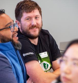 CARE Leader cohort members smile at each other