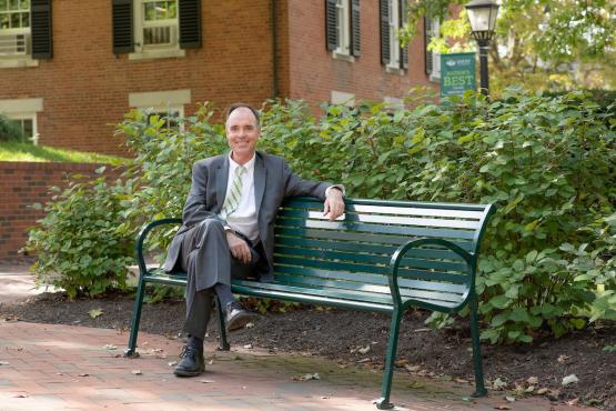 Dr. Ken Johnson sits on a bench