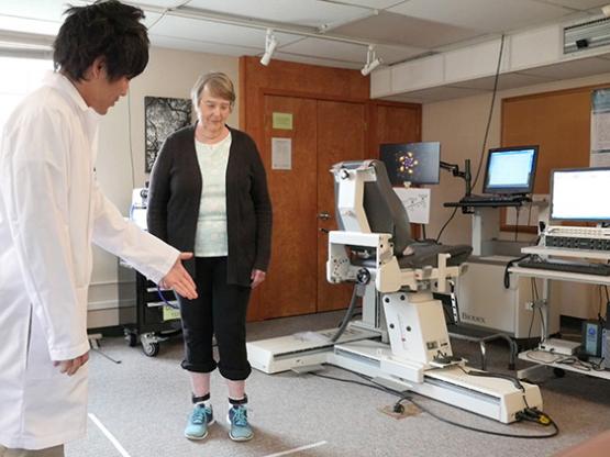 A professional helps someone work on mobility in Ohio University's Neuromuscular Physiology Laboratory.