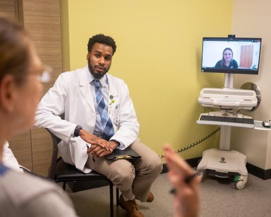 A Heritage College student sits in CTAC while video conferencing with another person