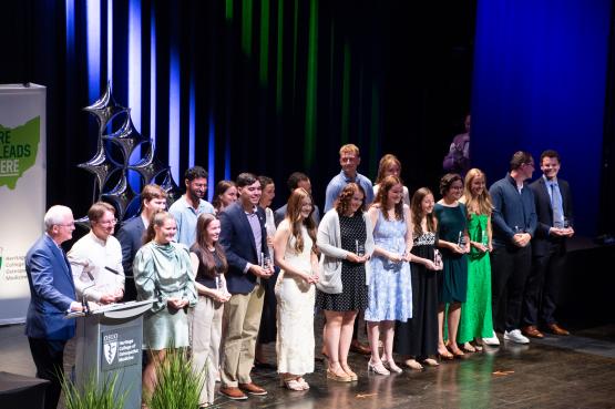 Award recipients stand on stage