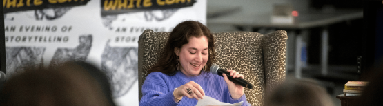Woman sitting in chair speaking into microphone