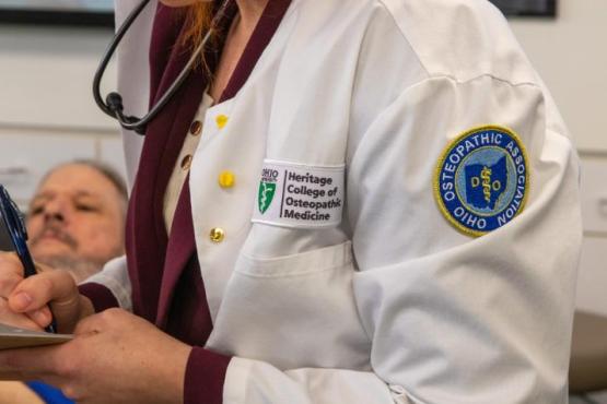 HCOM student takes notes during OMM lab