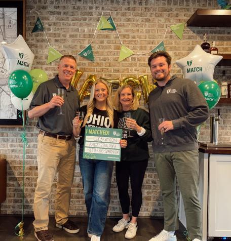 Lucille Gideon and family pose with Match Day sign