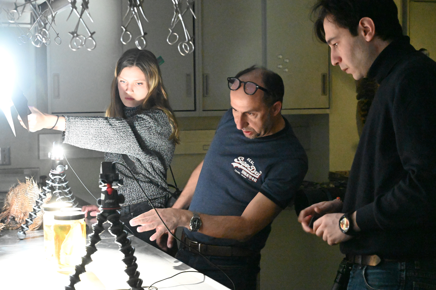 Madeleine Hordinski helps photographer Paolo Verzone and his assistant Massimo Nicolaci set up lighting for a photograph