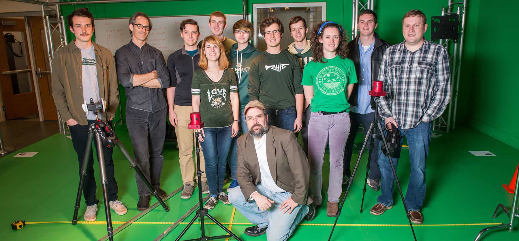 Members of the GRID Lab pose for a picture in front of a green screen.