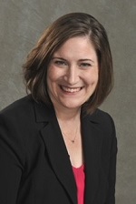 Woman with short brown hair and a black blazer