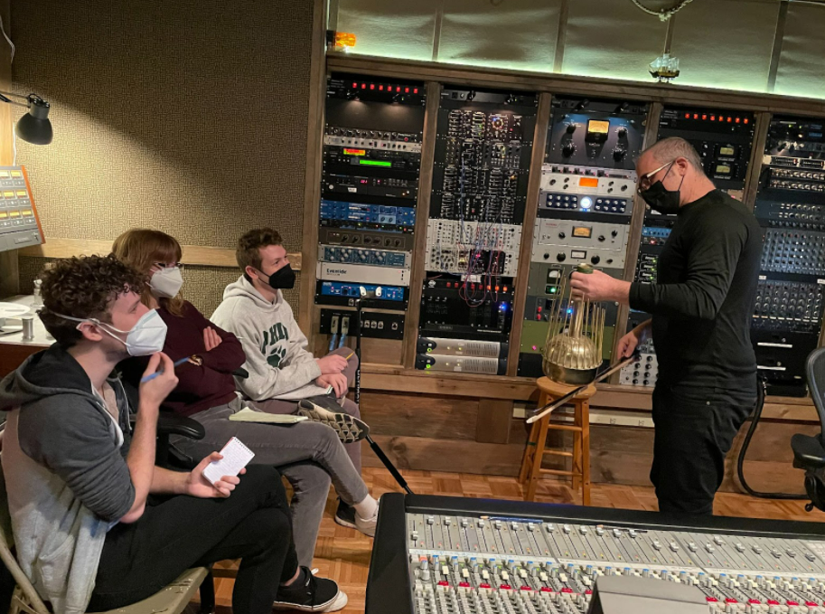 Music producer Joel Hamilton speaks to a group of OHIO students at a music production studio