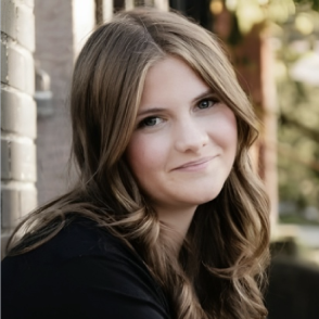 Photo of Reese Ballard sitting on steps outside.