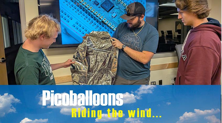 Wyatt Williams, Declan Herbert and Ethan Fiedtkou inspect the mylar picoballoon for the project.