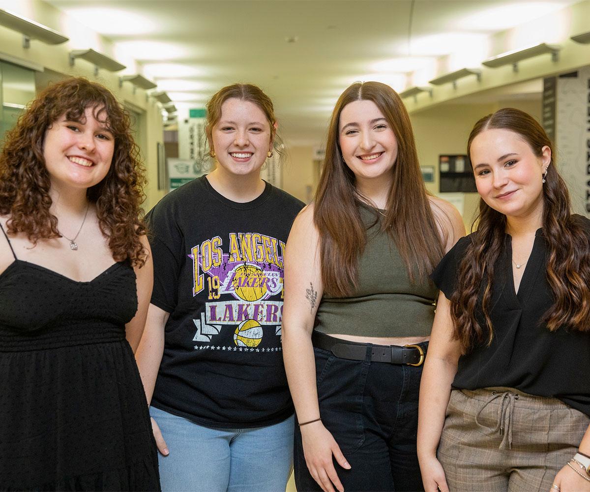 Four students pose for a photo together.
