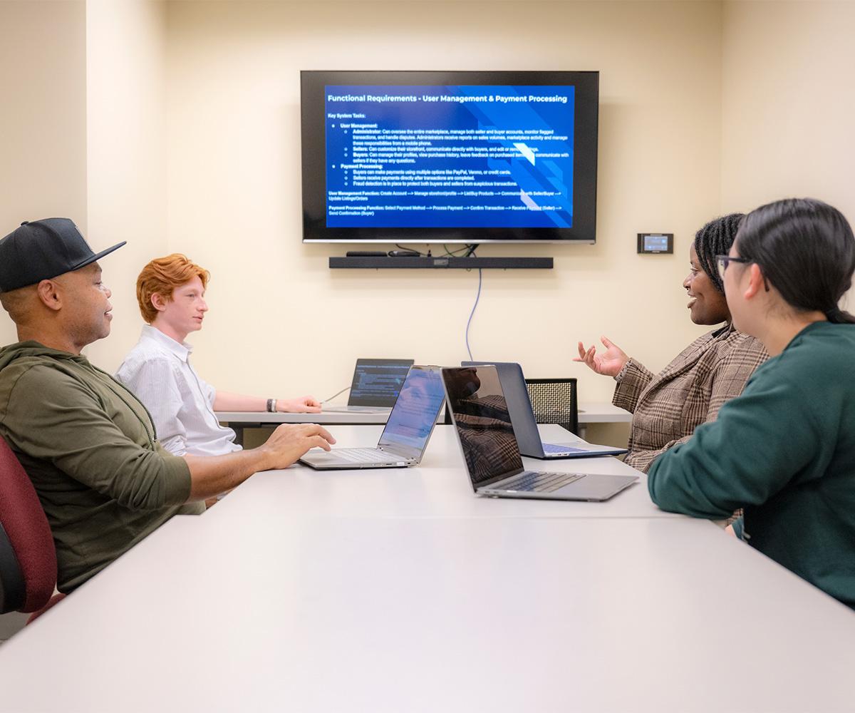 Students discuss new information in a classroom.