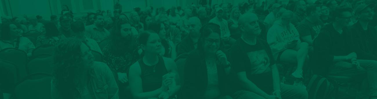 crowd sitting at a conference in a main conference hall