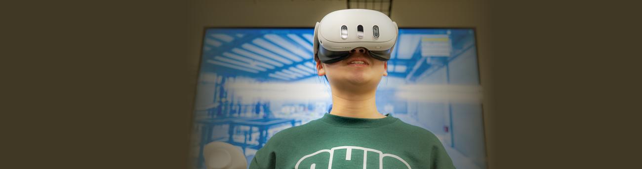 Student working with a VR headset.