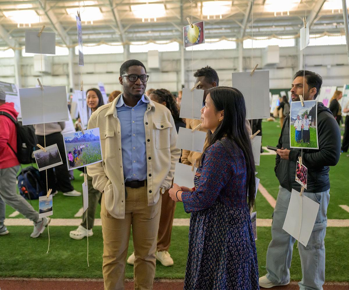Graduate students talk about their projects at the Student Expo.