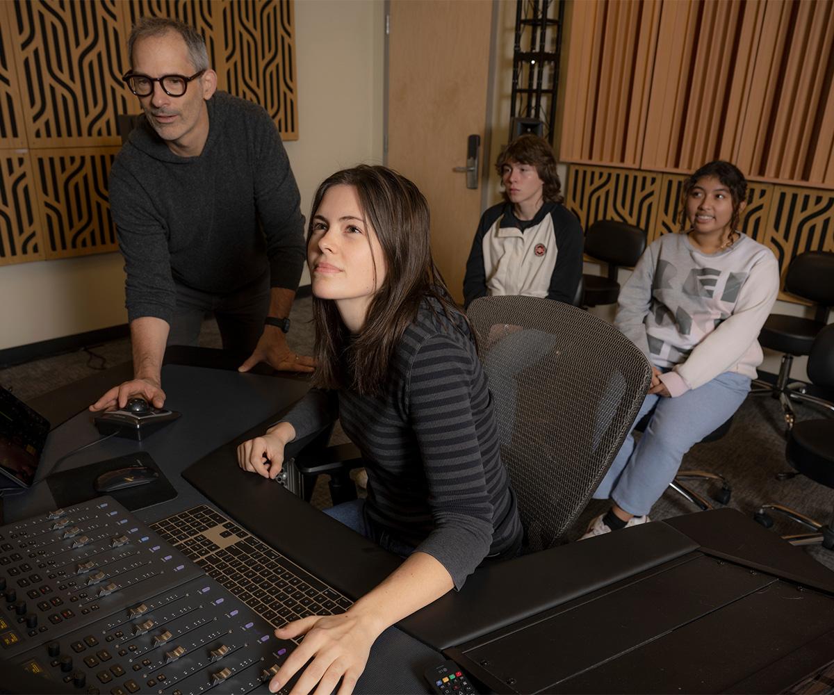 Professor Josh Antonuccio works with students in a mixing lab.