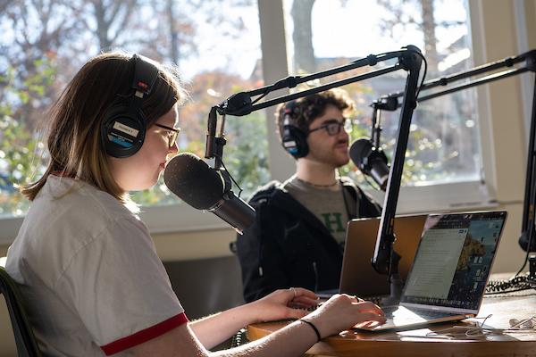 Two students record a podcast together