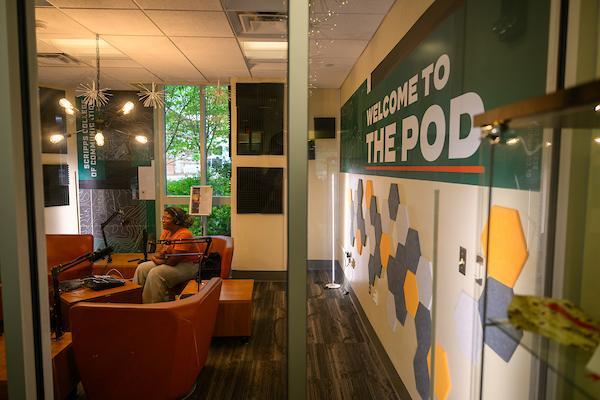 student recording a podcast in the studio