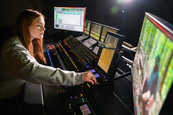 woman in the studio working on the sound of a video