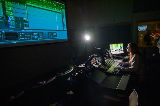 woman working on a video's sound in the studio