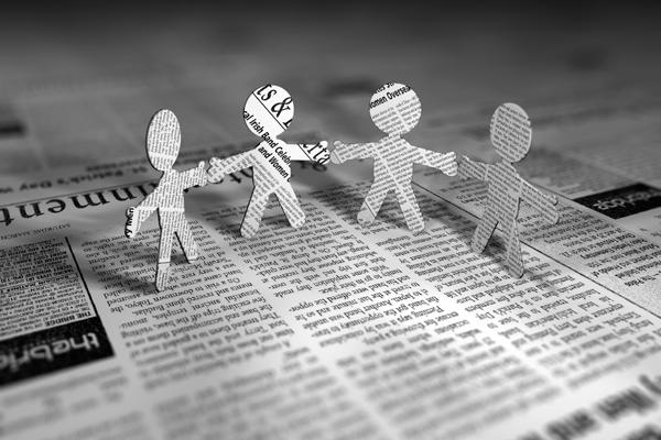 newspaper with people cutouts