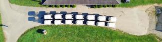 Birds-eye view of golf carts lined up on a path