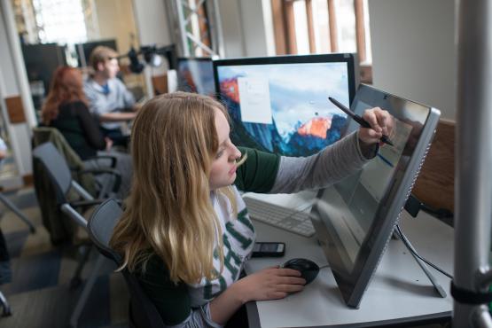 A student works on a touch-screen monitor