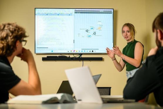 Students discussing a final project for the capstone course.