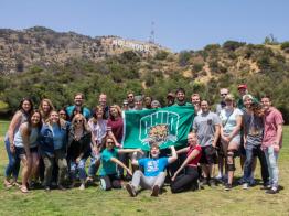 Students pose in front of the Hollywood sign