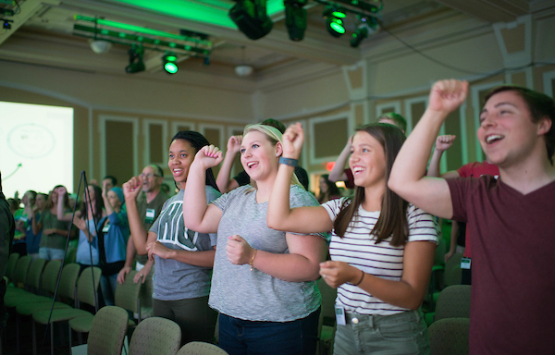 Enthusiastic students cheer at an event in Baker University Center