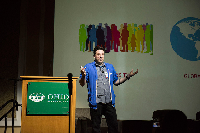 Chris Volpe speaking near the podium at the Business of Games Summit