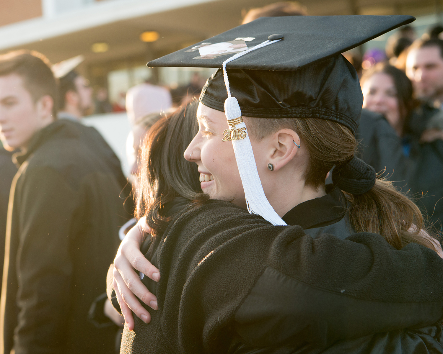 Student hugs a supporter at commencement 