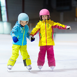 Two children learning to skate